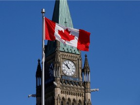 A Canadian flag flies in front of the Peace Tower on Parliament Hill in Ottawa, Ontario, Canada, March 22, 2017.