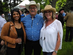 Sheeba Mathews of Alberta Government Adoption Services with Calgary Fish-Creek MLA Richard Gotfried and his wife Cathy Gotfried.
