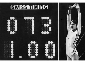 On this day in history, in 1976, Romanian Nadia Comaneci, performing on the uneven bars at the Montreal Olympics, scored the first perfect 10 in Olympic gymnastic history. Pictured, the scoreboard at the Forum shows "1.00" because it wasn't programmed to show a score of 10. Photo credit AFP/Getty Images.