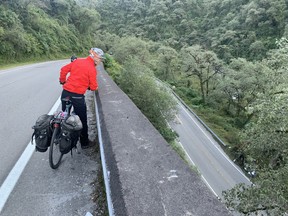 After pedaling to Paso Infiernillo (3,042 meters above sea level) in the province of Tucumán, Argentina, it was almost all downhill.  Jeff Wearmouth from Calgary studies the route.  Photo, Joanne Elves