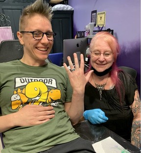 Rachael Romero shows off her newly tattooed ring finger done by Cherie Johnson at the Brentwood Angles salon.