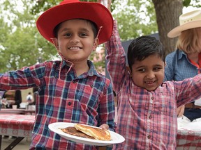 Abhinav, 9, and his brother Anirvan, 7, were excited to eat their pancake breakfast at Suncor Family Day at the 2016 Calgary Stampede on July 10, 2016.