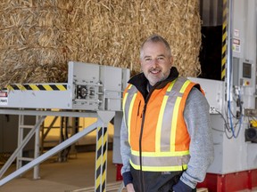 Darren Bondar, president and CEO of Hempalta, prepares to process a bale of hemp feedstock.