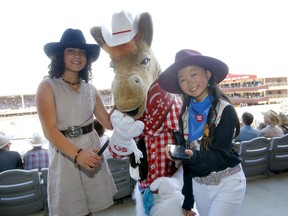 BMO junior reporters L-R, Yekta Gol and Aidan Cha interview Harry the Horse during Day 6 of the Calgary Stampede in Calgary on Wednesday, July 13, 2022.