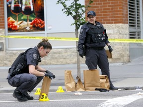 Calgary police investigate an early morning shooting in the Beltline at 14 ave. and 1 st. S.E. in Calgary on Saturday, July 2, 2022.