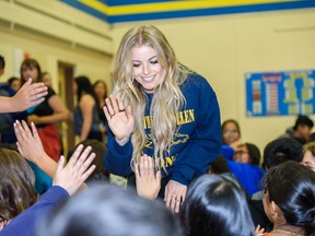 FILE PHOTO: CCMA nominee and Calgary native Lindsay Ell high-fives students as they exit the gymnasium at Father Scollen School after her performance on Thursday, September 5, 2019.