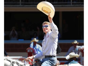Cowboy Tuf Cooper of Decatur, Texas, acknowledges the crowd on Day 5 of the tie-down roping event at the Calgary Stampede rodeo on Tuesday.