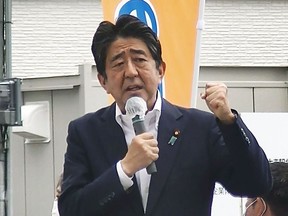 In this image from a video, Japan's former Prime Minister Shinzo Abe makes a campaign speech in Nara, western Japan shortly before he was shot Friday, July 8, 2022. Abe was shot during the speech and was airlifted to a hospital but he was not breathing and his heart had stopped, officials said. (Kyodo News via AP)