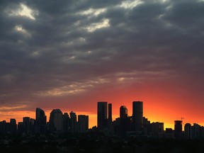 Downtown Calgary is backlit by the setting sun on Tuesday, July 26, 2022.