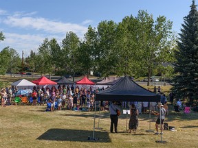 Sunday service at Bonavista Church is held in the green space across the street after the church was damaged by fire, which occurred early Friday, Sunday August 14, 2022.