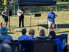 John Estabrooks, lead pastor at Bonavista Church, speaks at the outdoor Sunday service held at the green space across the street after the church was damaged from a fire, which took place early Friday, on Sunday, August 14, 2022.