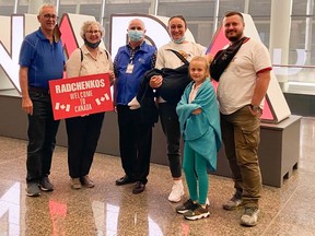 A local host couple greets the Radchenko family with CCIS staff member Sarwar Arkan (middle) at the Calgary International Airport.