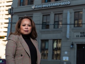 Rowena Browne, chief development officer at The Mustard Seed, poses for a photo with the non-profit organization's historical building in the background on Wednesday, November 24, 2021.