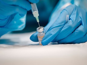 A nurse prepares the Pfizer-BioNTech COVID-19 vaccine in Montreal, Quebec on November 24, 2021.