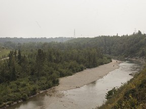 Smoke-filled skies as seen overlooking the Elbow River from River Park in Calgary's southwest on Saturday, Aug. 11, 2018. KERIANNE SPROULE/POSTMEDIA