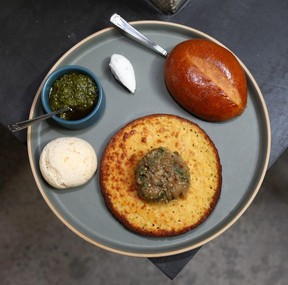 A plate of daily bread (three pieces with rotating butter and spreads) is on display at Fortuna's Row. Jim Wells/Postmedia