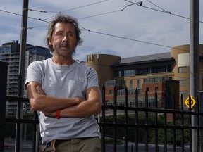 Longtime East Village resident Steve Gin poses for a picture in front of the Calgary Drop-In Centre in Calgary on Wednesday, August 3, 2022.