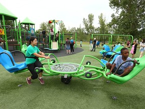 Children, parents and caregivers enjoy a new inclusive playground on Wednesday, August 3, 2022 in Sandy Beach where all Calgarians can play, no matter their abilities. The park is one of 10 recently completed in Calgary.