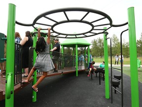 Children, parents and caregivers enjoy a new inclusive playground on Wednesday, August 3, 2022 in Sandy Beach where all Calgarians can play, no matter their abilities. The park is one of 10 recently completed in Calgary.