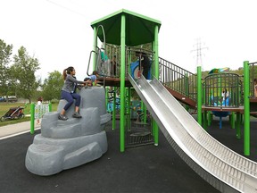 Children, parents and caregivers enjoy a new inclusive playground on Wednesday, August 3, 2022 in Sandy Beach where all Calgarians can play, no matter their abilities. The park is one of 10 recently completed in Calgary.
