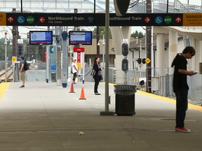 Passengers wait on the platform at the Heritage LRT Station in Calgary on Wednesday, August 10, 2022.