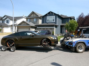 A vehicle involved in a shooting incident is towed from Everwoods Court S.W. in Calgary on Thursday.