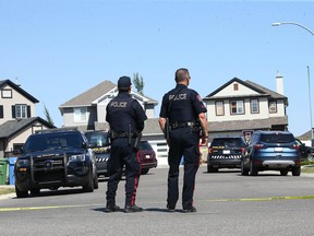 Calgary Police investigate at the scene of a shooting in 100 block of Everwoods Court S.W. in Calgary on Thursday.