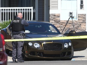 Calgary Police investigate at the scene of a shooting in 100 blk of Everwoods Court SW in Calgary on Thursday, August 18, 2022. A woman was deceased at the scene and a man was taken to hospital in life-threatening condition.