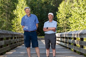 Friends Ben Benjaminy (right) and Dror Goldreich, seen in Edmonton, on Thursday, Aug. 25, 2022. The two men have enjoyed a brisk, six-kilometre walk along trails near their west-end homes nearly every morning for the past 20 years.