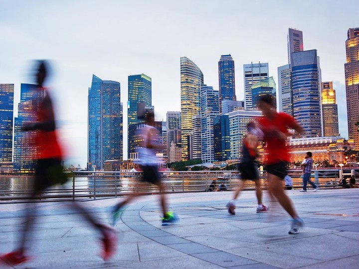  Men running in the evening in Singapore. Files