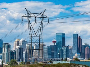 Enmax power lines are seen with the Calgary skyline as a backdrop on Tuesday, August 16, 2022.