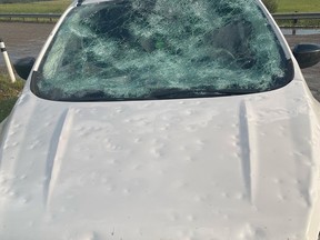 Damage to a car is shown after a hailstorm near Innisfail on Monday. Environment and Climate Change Canada says hail ranging from the size of a pea to a softball fell in central Alberta.