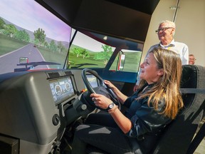 Deputy Prime Minister Chrystia Freeland tries out a truck simulator with Bison Transport Safety Counselor David Cousins while visiting the company's Calgary depot on Wednesday, August 31, 2022.