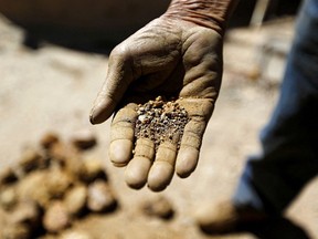 An artisanal miner shows ore at a small copper and gold processing plant in Chile.