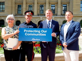 L-R, Jean Bota, president, Alberta Community Crime, Mark Neufeld, Chief Constable, Calgary Police Service, Tyler Shandro, Minister of Justice and Solicitor General and Mark Gerlitz, director, Calgary Crime Stoppers during a press conference as the Alberta government announced new supports for crime prevention projects and initiatives in Calgary on Wednesday, August 24, 2022.