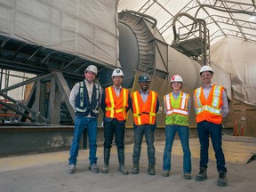 Apoorv Sinha, centre, CEO of Carbon Upcycling Technologies and staff in front of the Calgary company's commercial reactor at the Calgary plant.
