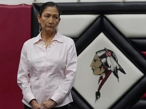 U.S. Secretary of the Interior Deb Haaland listens during ceremonies before a meeting to hear about the painful experiences of Native Americans who were sent to government-backed boarding schools designed to strip them of their cultural identities Saturday, July 9, 2022 in Anadarko, Okla. The president of the National Congress of American Indians says Canada's progress on Indigenous issues is helping to push the United States in the same direction.