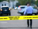 A crime scene is taped off where a body was found in the middle of the street on 18th Ave. and Victoria Crescent N.W. on Thursday, August 25, 2022.