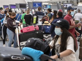 Travellers line up at Toronto Pearson International Airport’s Terminal 1 in July.