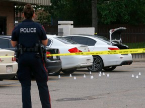 Calgary police pictured on scene of another shooting in a parking lot of a strip mall at 5th Ave. and 28th St. S.E. in Calgary on Tuesday, August 23, 2022.