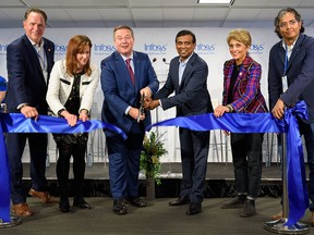 From left; Brad Parry, Calgary Economic Development president and CEO, Minister Tanya Fir, Premier Jason Kenney, Infosys president Ravi Kumar, and Mayor Jyoti Gondek cut the ribbon at the Infosys announcement event on Monday, September 26, 2022.