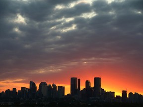 The Calgary downtown skyline is lit by a sunset on Tuesday, July 26, 2022.