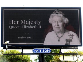 An electronic billboard with an image of Queen Elizabeth II is displayed in downtown Calgary on Thursday, September 8, 2022.