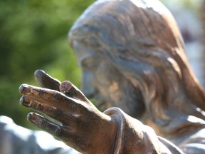 Damage is shown to a religious statue in front of Sacred Heart Church on 14 St SW in Calgary on Friday, September 9, 2022. Police say the offender fled on foot and the Hate Crime and Extremism team is investigating. Jim Wells/Postmedia