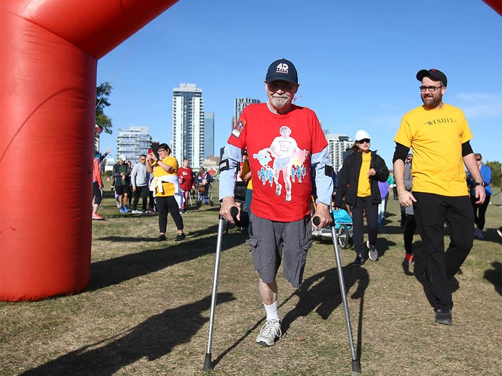  Don Cowie, (L) who lost his leg to cancer, passes the start line at the Terry Fox Run held at Fort Calgary in downtown Calgary on Sunday, September 18, 2022.