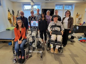 Stewart Midwinter, front right, inspired more than $200,000 in donations. Here he appears with donors and representatives of Spinal Cord Injury Alberta.