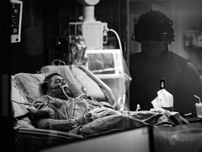 A COVID-19 patient lies in bed, watched by a nurse clinician, on the day before he was intubated. Excerpts were originally published in Shadows and Light: A Physician’s Lens on COVID copyright © 2022 by Heather Patterson. Reprinted by permission of Goose Lane Editions.