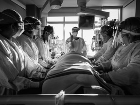 Officials prepare for the proning of a COVID-19 patient. Excerpts were originally published in Shadows and Light: A Physician’s Lens on COVID copyright © 2022 by Heather Patterson. Reprinted by permission of Goose Lane Editions.