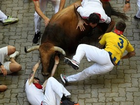 A participant is gored by a Jose Cebada Gago bull during the fifth "encierro" (bull-run) of the San Fermin festival in Pamplona, northern Spain on July 11, 2022. Pamplona's San Fermin running of the bulls, immortalized by Literature Nobel Prize winner and novelist Ernest Hemingway, is the prime event but there has not been a death there in 13 years.