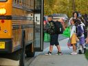 Students board a school bus on the first day of school in Calgary on Thursday, September 1, 2022. 